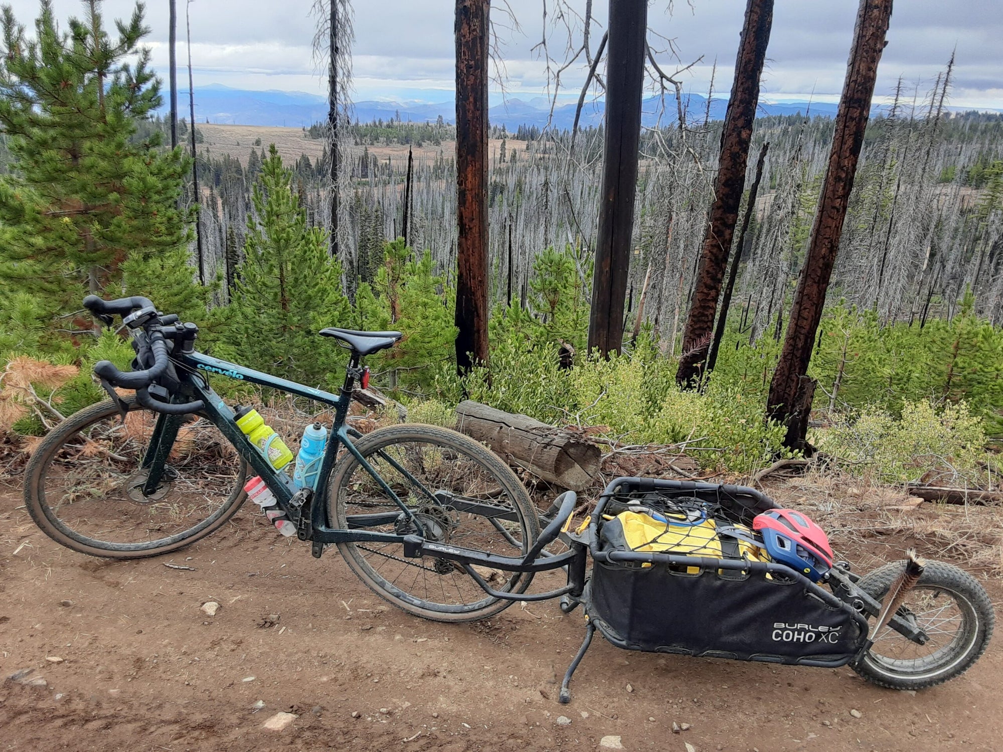 bike with coho xc bike trailer attached sitting on dirt road overlooking valley