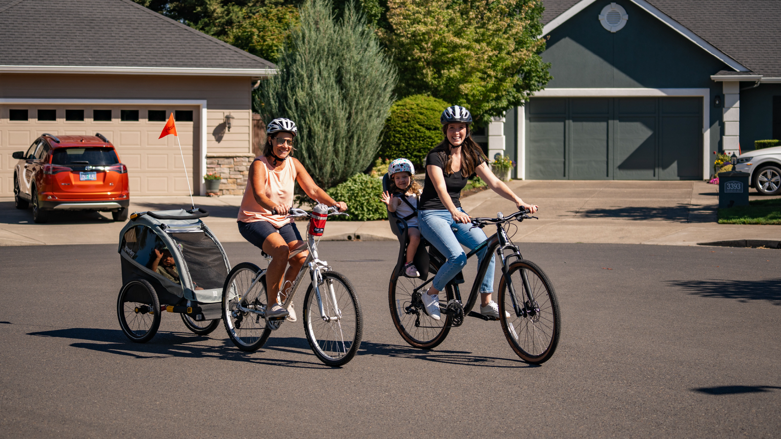 Family with kids in Burley Kid Bike Trailer and Dash Child Bike Seat