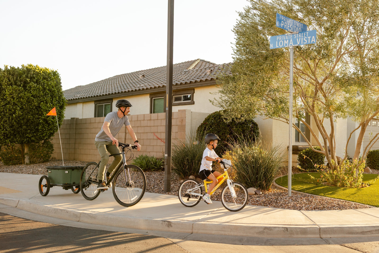 Parent biking with Burley Hopper and child on their own bike