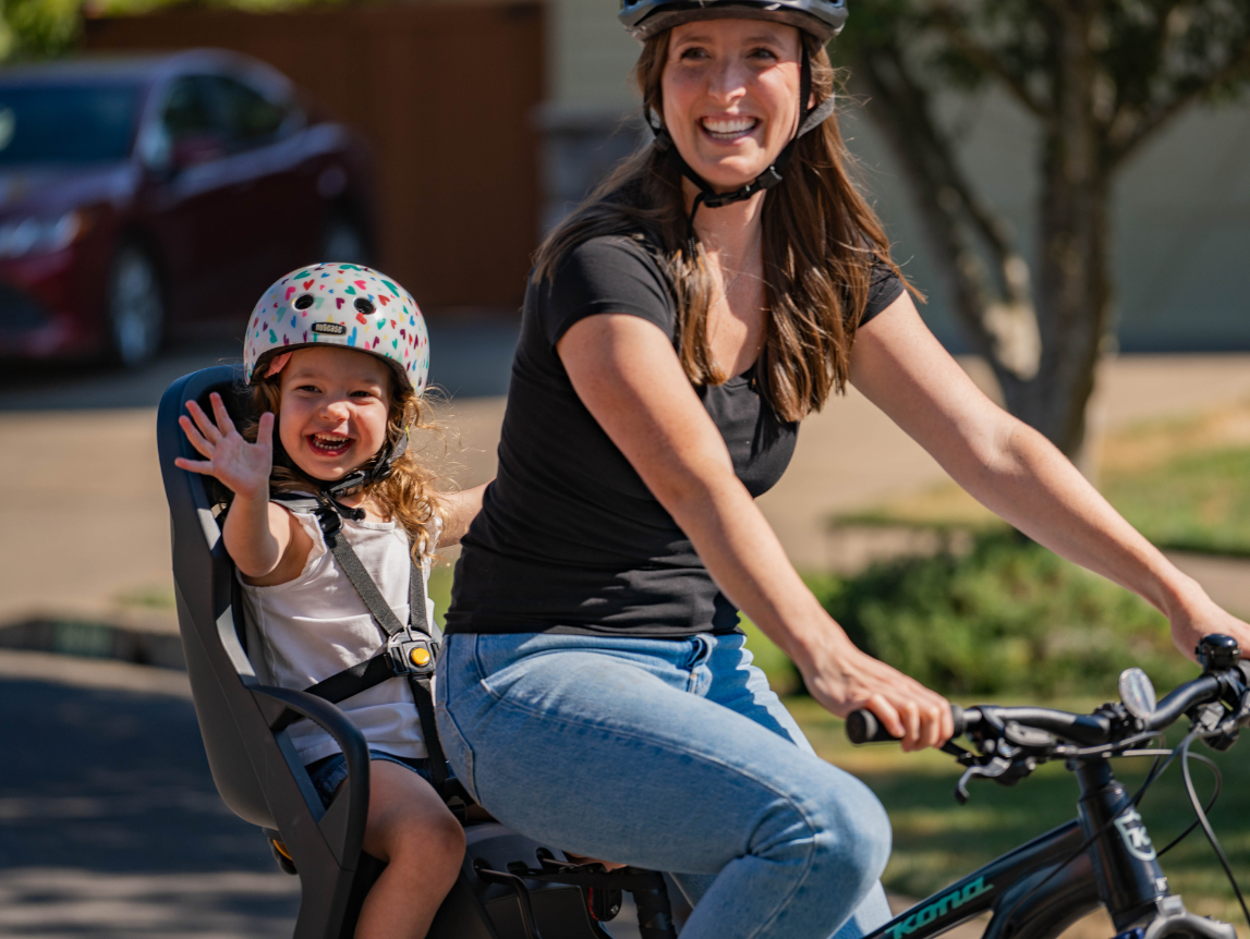 Parent biking with child in Dash Kid Bike Seat