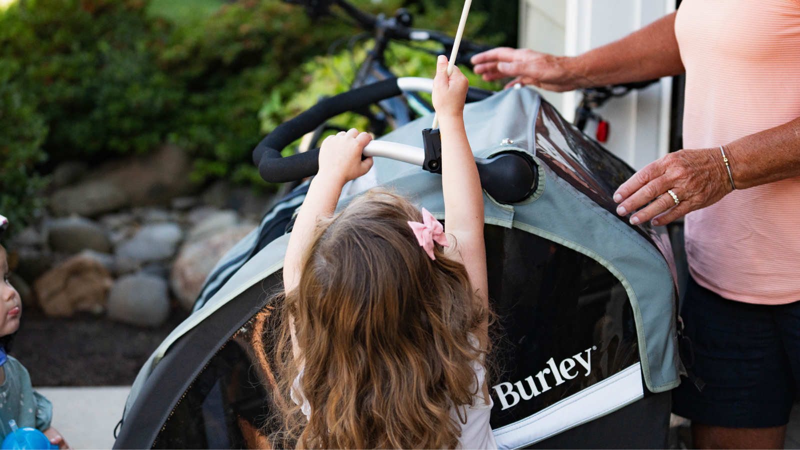Child placing safety flag in Burley Bike Trailer