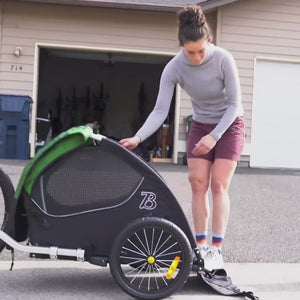 Video showing cyclist loading dog in Tail Wagon trailer and riding on bike paths then folding trailer and storing in vehicle.