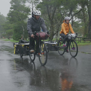 Video of Coho XC Cargo Trailer cycling in rain with dry bags and using kickstand to hold trailer upright while unloading.
